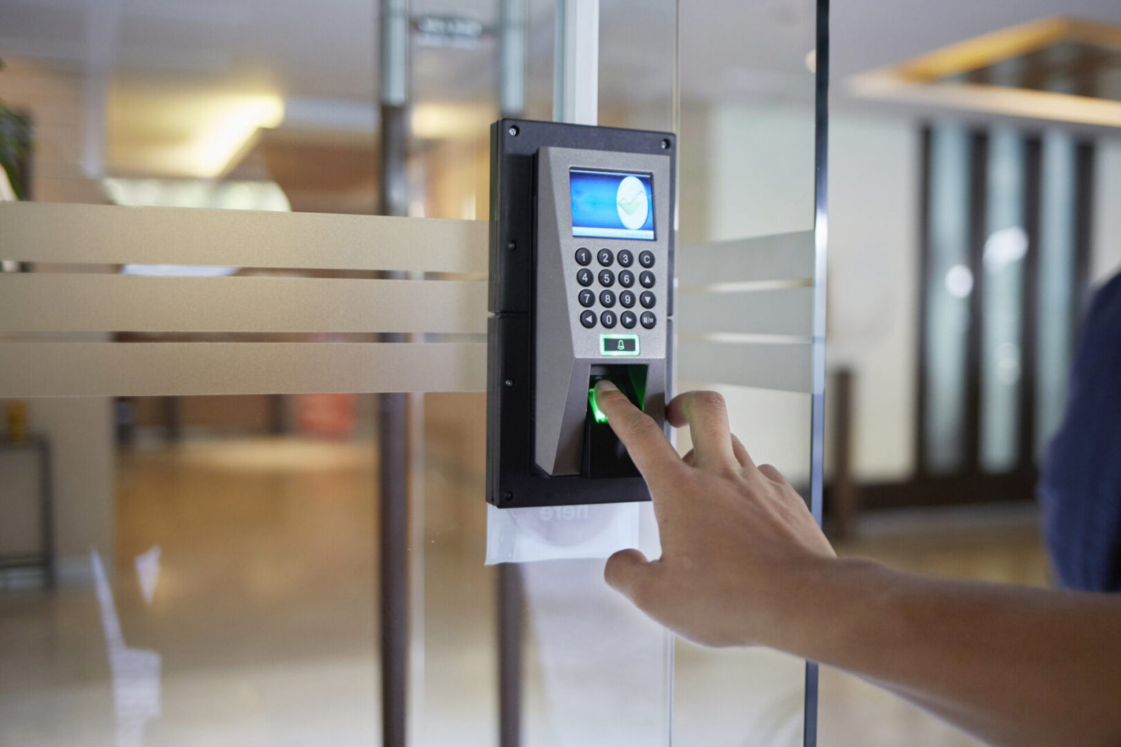 Person using fingerprint access control system.